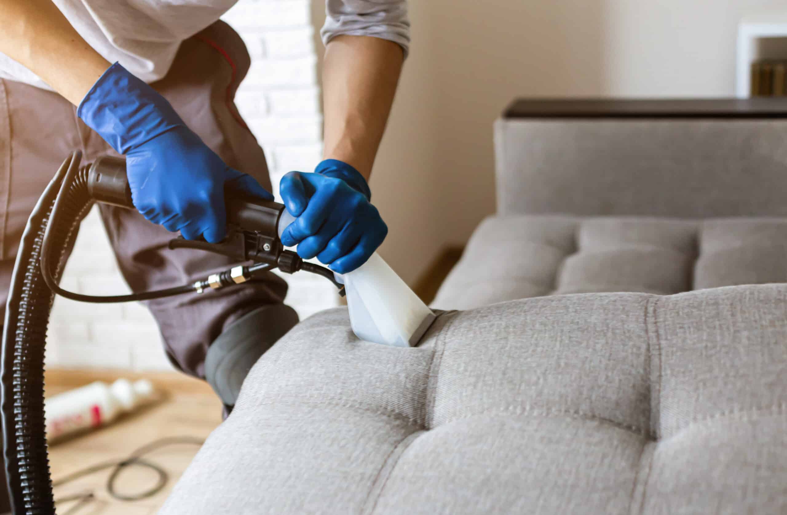 Man hot water extracting residential upholstery furniture in Syracuse, NY